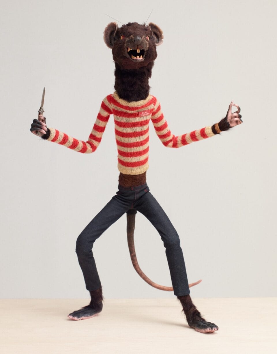 a skinny puppet of a rat