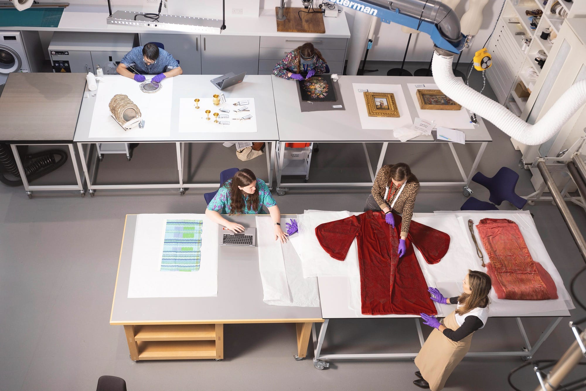 conservators work in a conservation area of museum collection storehouse